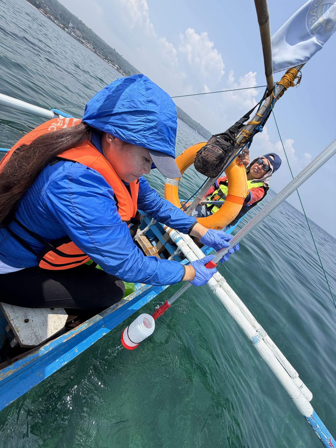 On-boat water sampling aboard a “bangka”, a traditional Southeast Asian outrigger vessel that can be propelled by a small gasoline- or diesel-powered engine, a single-cylinder water pump engine, or even a repurposed automobile engine. Iligan Bay, Philippines, September 2026.